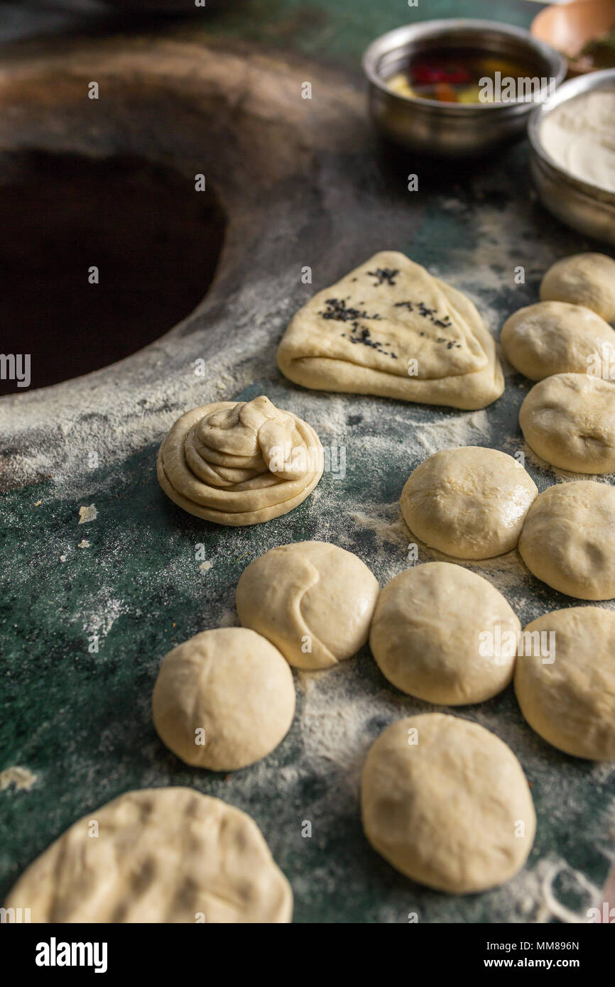 Ingredienti per il tandoori naan o roti - indiano piatto pane cotto nel forno di argilla. Olio, pasta, alla farina e alle spezie sulla parte superiore del forno tandoori Foto Stock