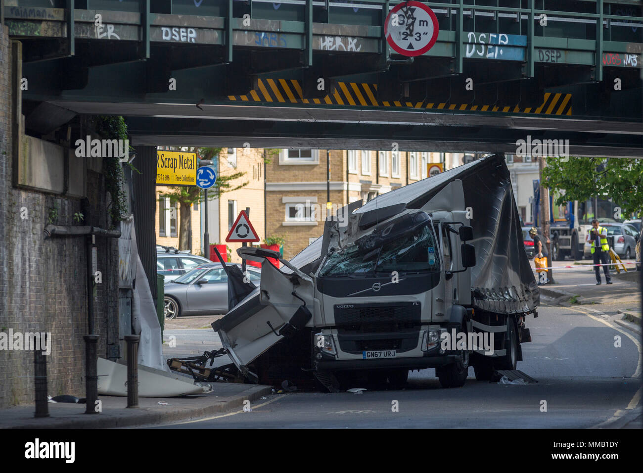 Il danneggiato rimane di un camion vicino a un metallo di scarto yard a Loughborough incrocio dopo si è schiantato in uno dei ponti ferroviari - la principale via di trasporto per pendolari in città il 8 maggio 2018, nella parte sud di Londra, Inghilterra. Una persona è stata ferita. Foto Stock