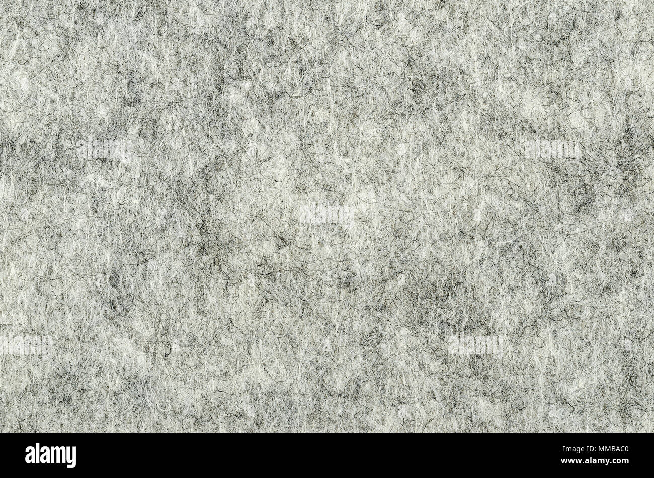 Grigio superficie feltro. Materiale tessile, fatta di stuoia di fibre sintetiche. Bianco, grigio e nero di acrilico premuti insieme. Modello di tessuto. Sfondo. Foto Stock