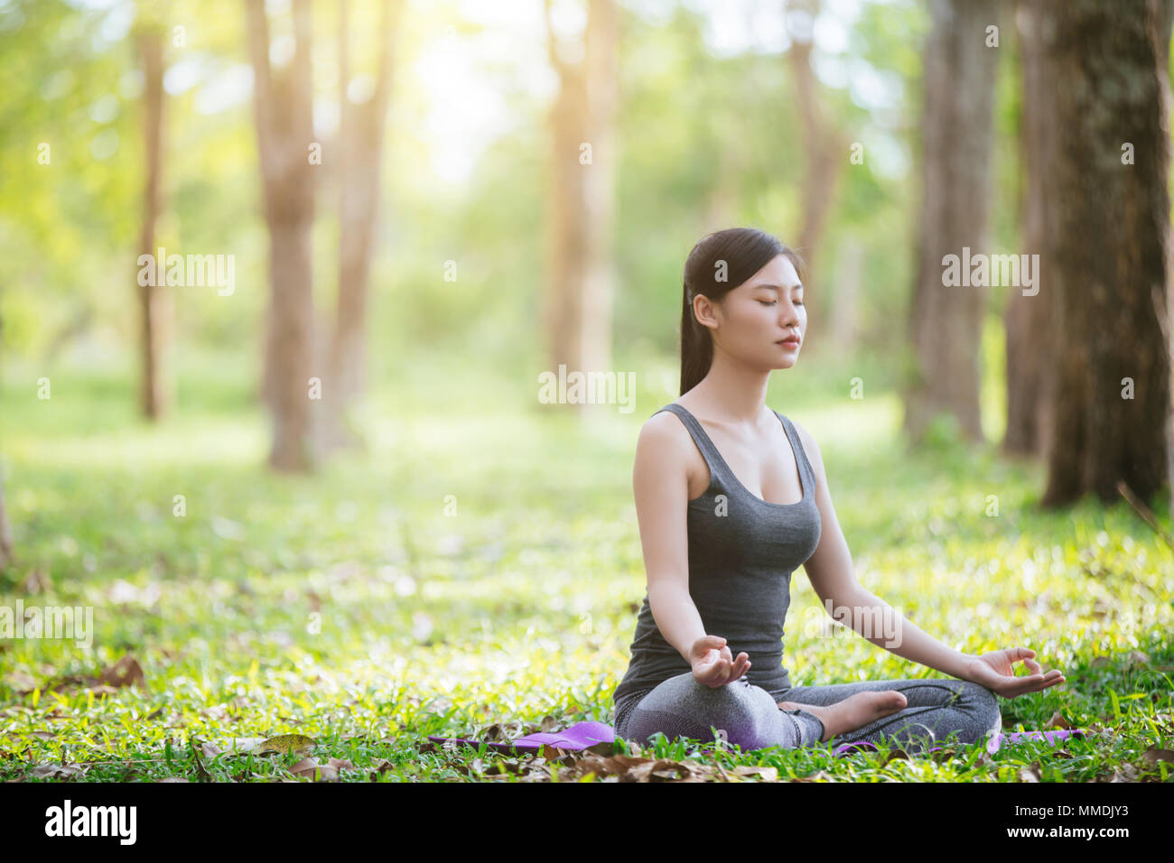 Signora la pratica dello yoga nel parco all'aperto, la meditazione. Foto Stock