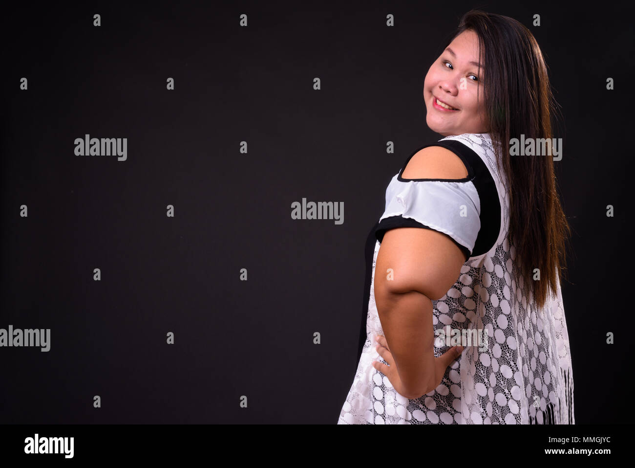 Bellissimo il sovrappeso donna asiatica su sfondo nero Foto Stock