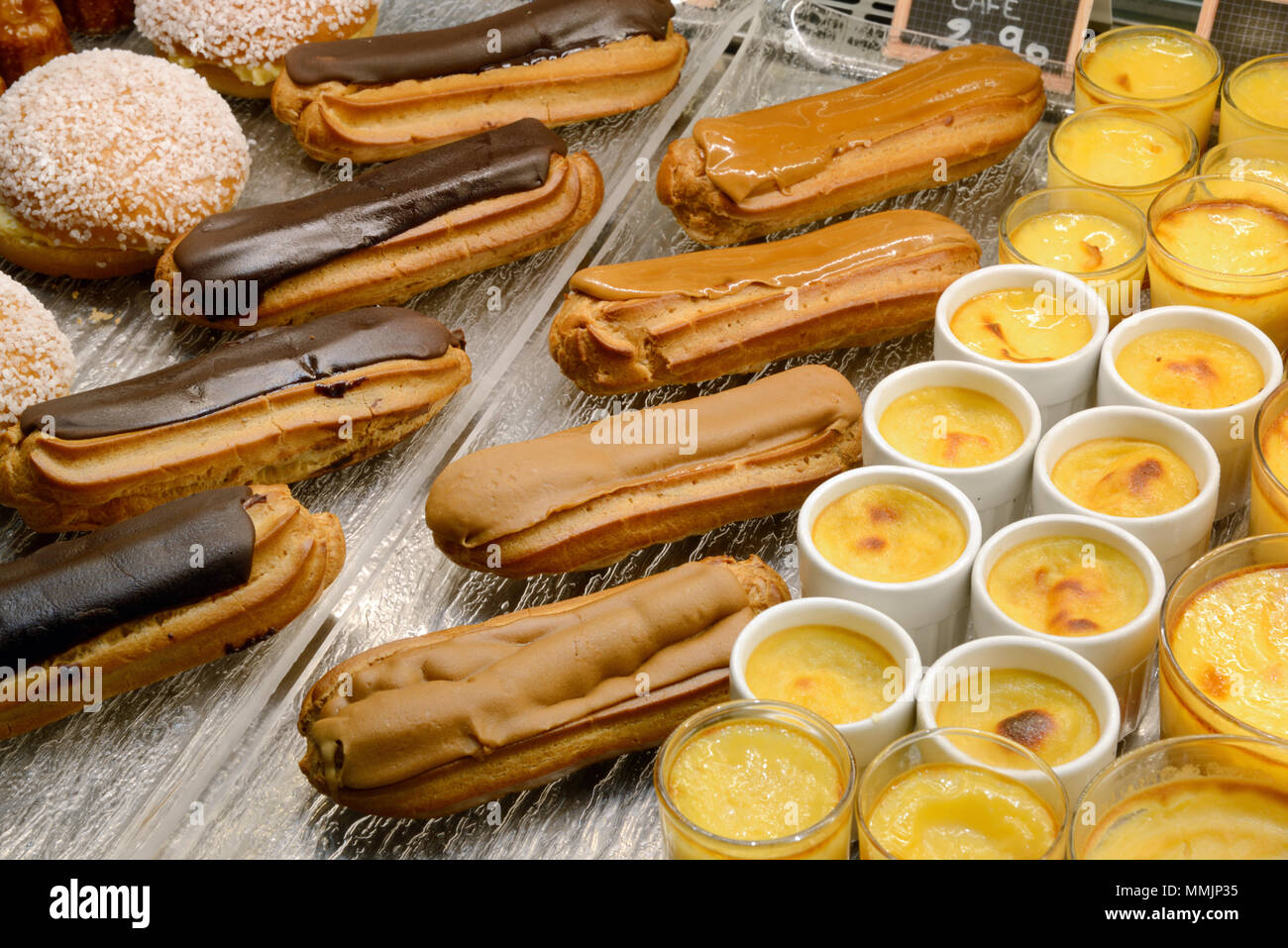 Visualizzazione di Eclairs al cioccolato, caffè Eclairs e creme caramelle & dolci o torte in una pasticceria francese in Francia Foto Stock