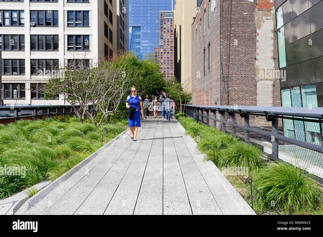 Persone che camminano sul parco High Line di New York. Il parco ha portato a rapidi cambiamenti nel quartiere di Chelsea e divenne uno strumento di gentrificazione Foto Stock