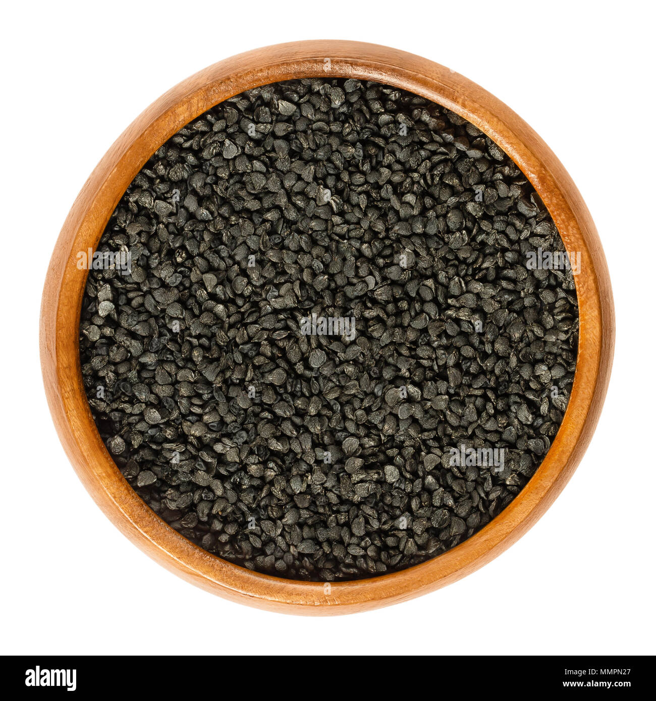 Semi di porro in ciotola di legno. Semi secchi di Allium ampeloprasum utilizzato per la germogliazione, germinazione e consumo. Commestibile, materie organiche e vegane. Foto Stock