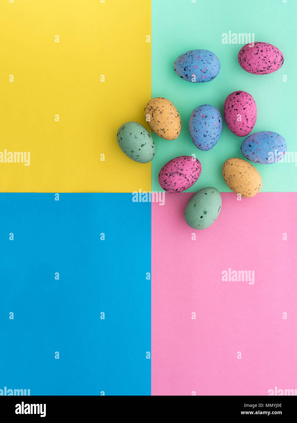 Mini punteggiate di uova di pasqua da sopra su sfondi colorati, con copyspace. Foto Stock
