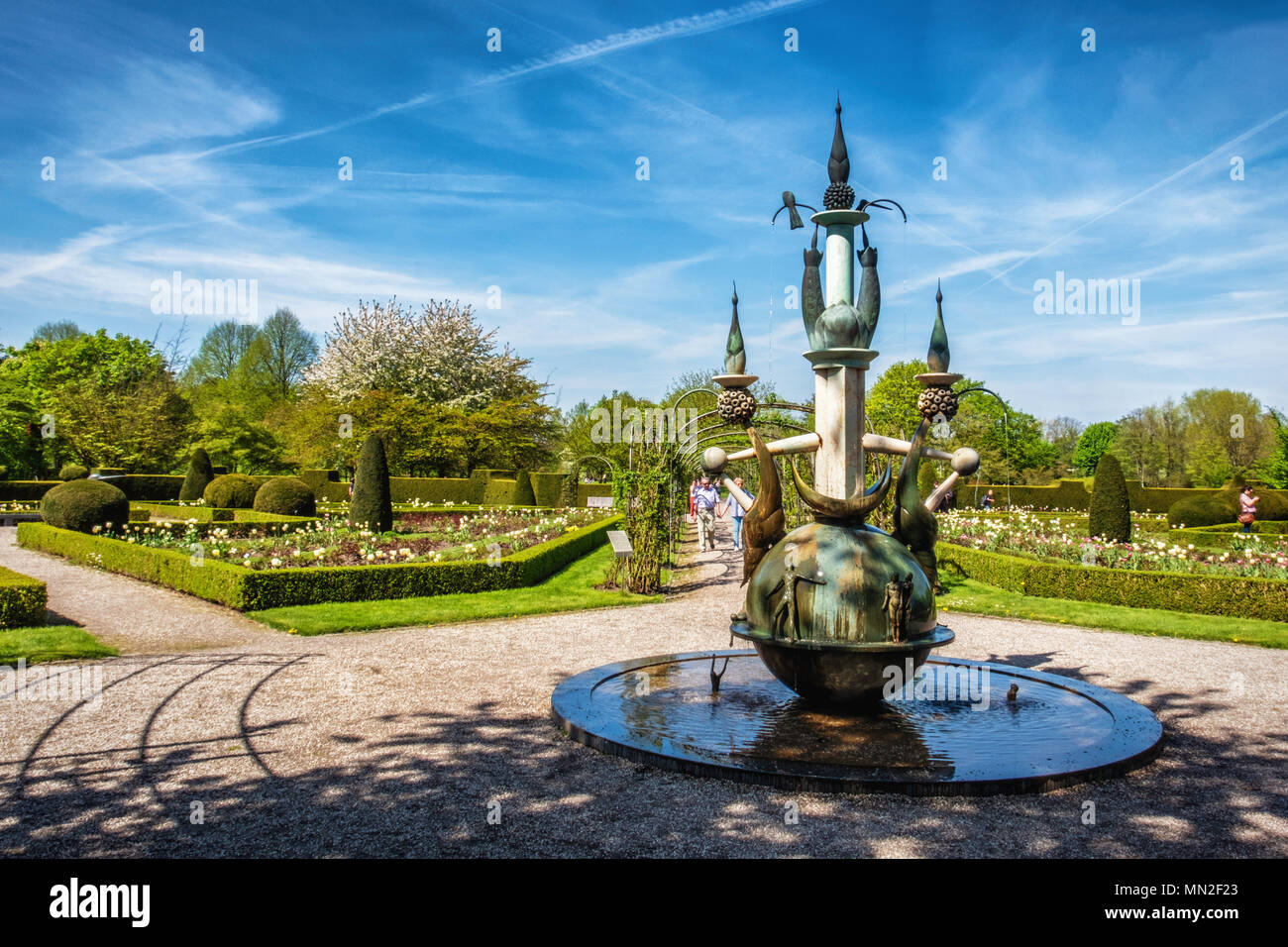 Britzer Garten, Neukölln, Berlino, Germania. 2018.formale Giardino di Rose in primavera con fontana e Potatura siepi, arbusti e tulipani e gente che camminava sul percorso Foto Stock