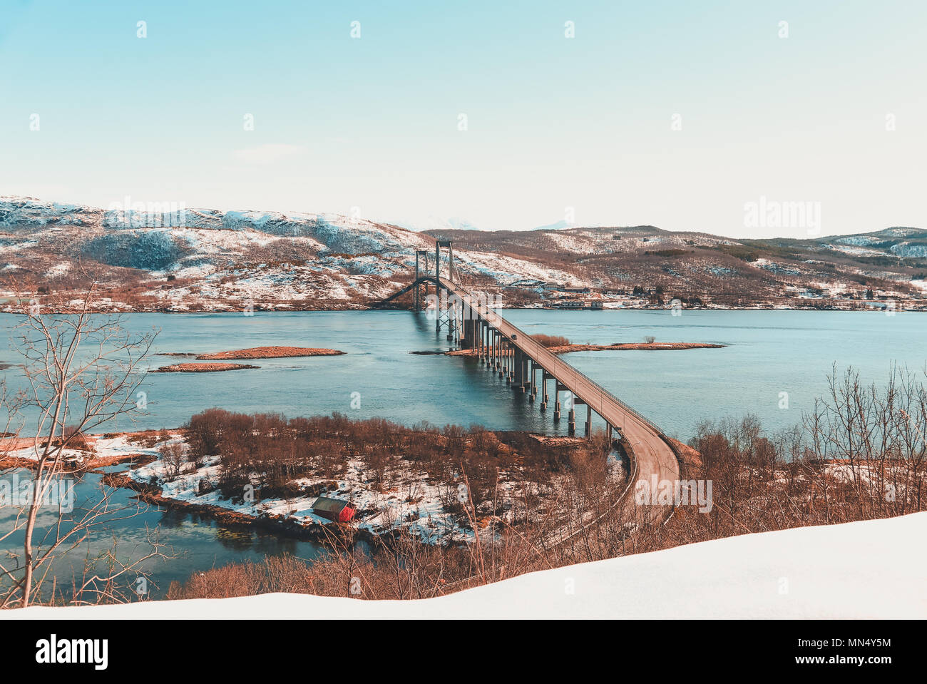 Norvegia, Tjeldsund bridge, uno dei numerosi ponti che assieme con gallerie collegano le isole Lofoten insieme. Ancora la neve, anche se la forza della molla Foto Stock