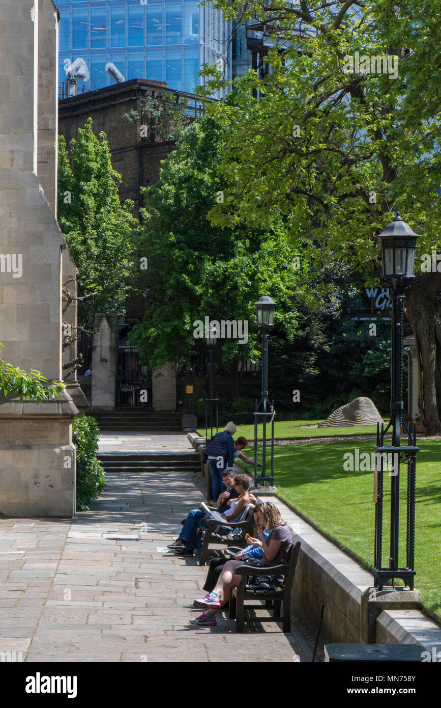 La gente seduta nella motivazione della Cattedrale di Southwark in estate prendendo o mangiare il loro pranzo durante una pausa. Foto Stock