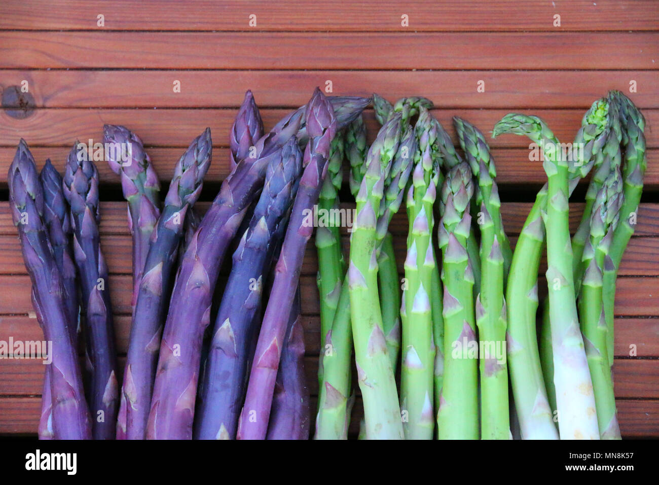 Verde e viola gli asparagi. Molto sano vegetale ungherese dal grande mercato. Foto Stock