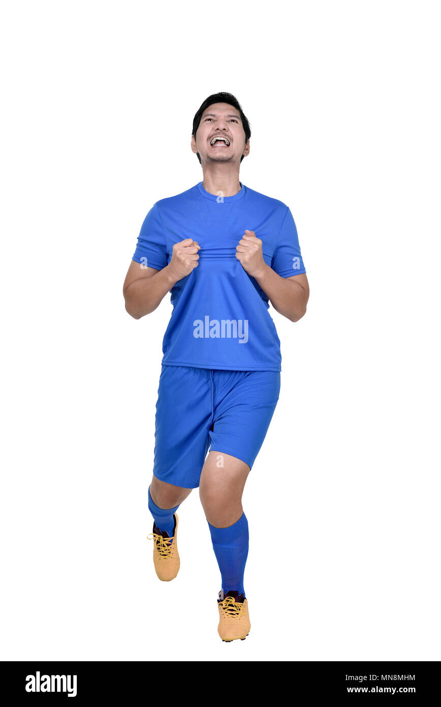 Felice asian giocatore di football uomo celebrare dopo un goal isolate su sfondo bianco Foto Stock