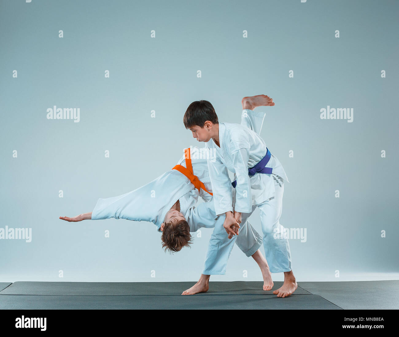 I due ragazzi di combattere ad Aikido la formazione nella scuola di arti marziali. Uno stile di vita sano e concetto di sport Foto Stock