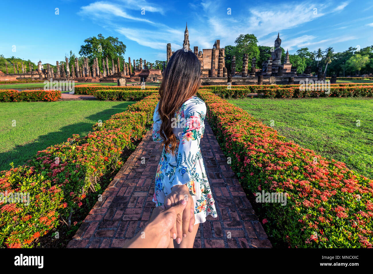 Donna Uomo tenendo la mano e conduce a lui di Wat Mahathat Tempio nel distretto di Sukhothai Historical Park, Wat Mahathat Tempio è UNESCO World Heri Foto Stock