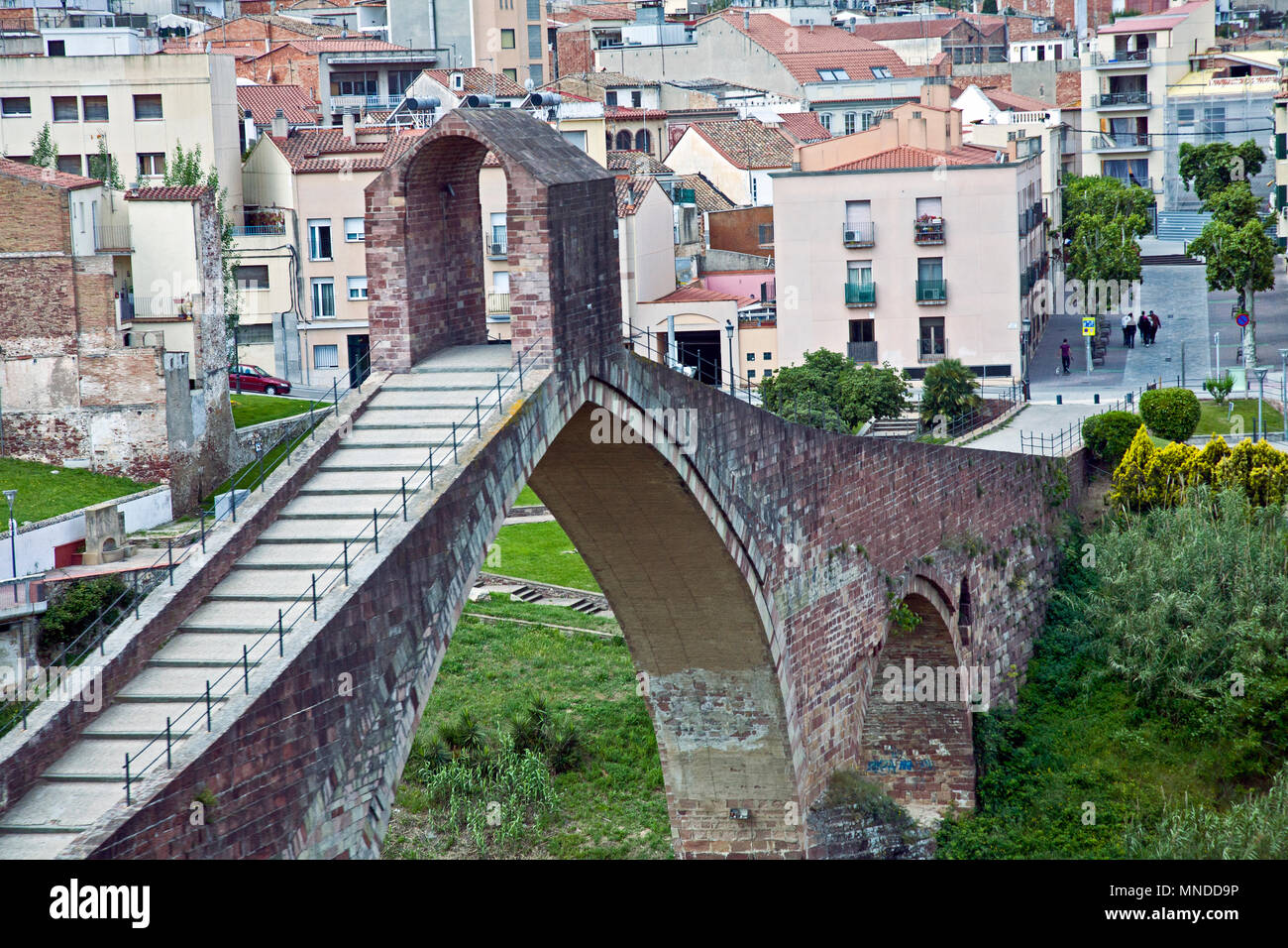 L'interessante architettura romana costruita 'Devil's bridge' a Barcellona Spagna con case in dietro Foto Stock