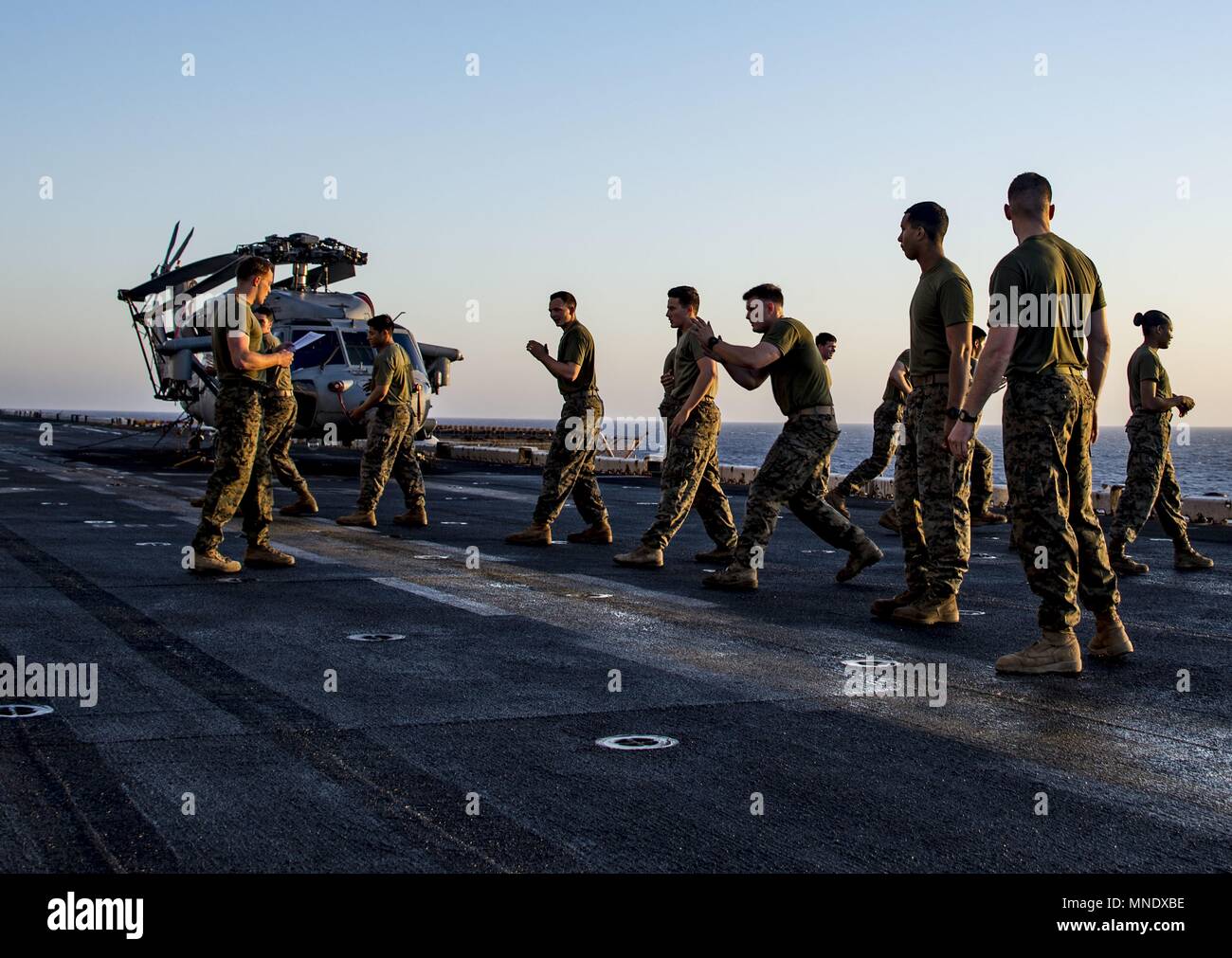 180515-N-ZK016-0002 U.S. 5TH FLOTTA AREA DI OPERAZIONI (15 maggio 2018) Marines, assegnato al XXVI Marine Expeditionary pratica unità di combattimento a mani nude esercita sul ponte di volo dell'Wasp-classe assalto anfibio nave USS Iwo Jima (LHD 7), 15 maggio 2018, 15 maggio 2018. Iwo Jima, homeported a Mayport, Fla. è sulla distribuzione per gli Stati Uniti Quinta Flotta area di operazioni a sostegno della sicurezza marittima operazioni per rassicurare gli alleati e partner e preservare la libertà di navigazione e il libero flusso di commercio nella regione. (U.S. Foto di Marina di Massa lo specialista di comunicazione di terza classe Joe J. Ca Foto Stock