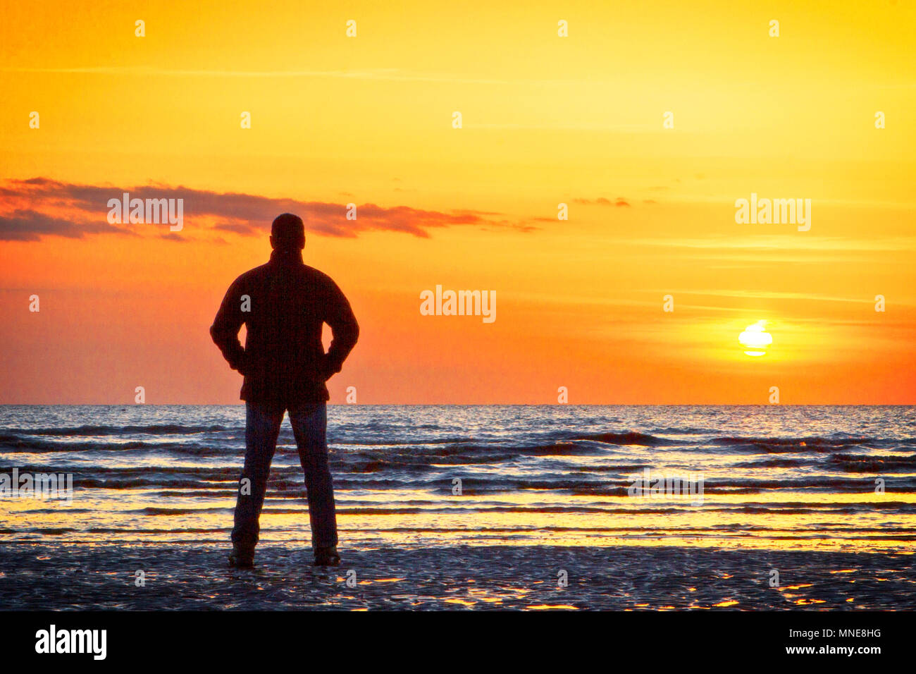 Crosby, Merseyside. 16 maggio 2018. Regno Unito Meteo. Dopo una giornata di condizioni atmosferiche variabili nel corso Inghilterra del nord ovest, sta un uomo da solo a guardare il tramonto dalla riva del mare off Crosby costa nel Merseyside. Credito: Cernan Elias/Alamy Live News Foto Stock