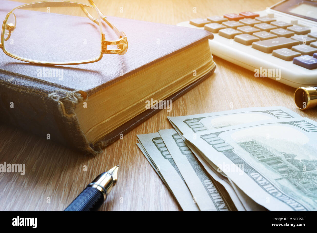 Il risparmio pensionistico. Soldi, bicchieri e pillole su una scrivania. Foto Stock