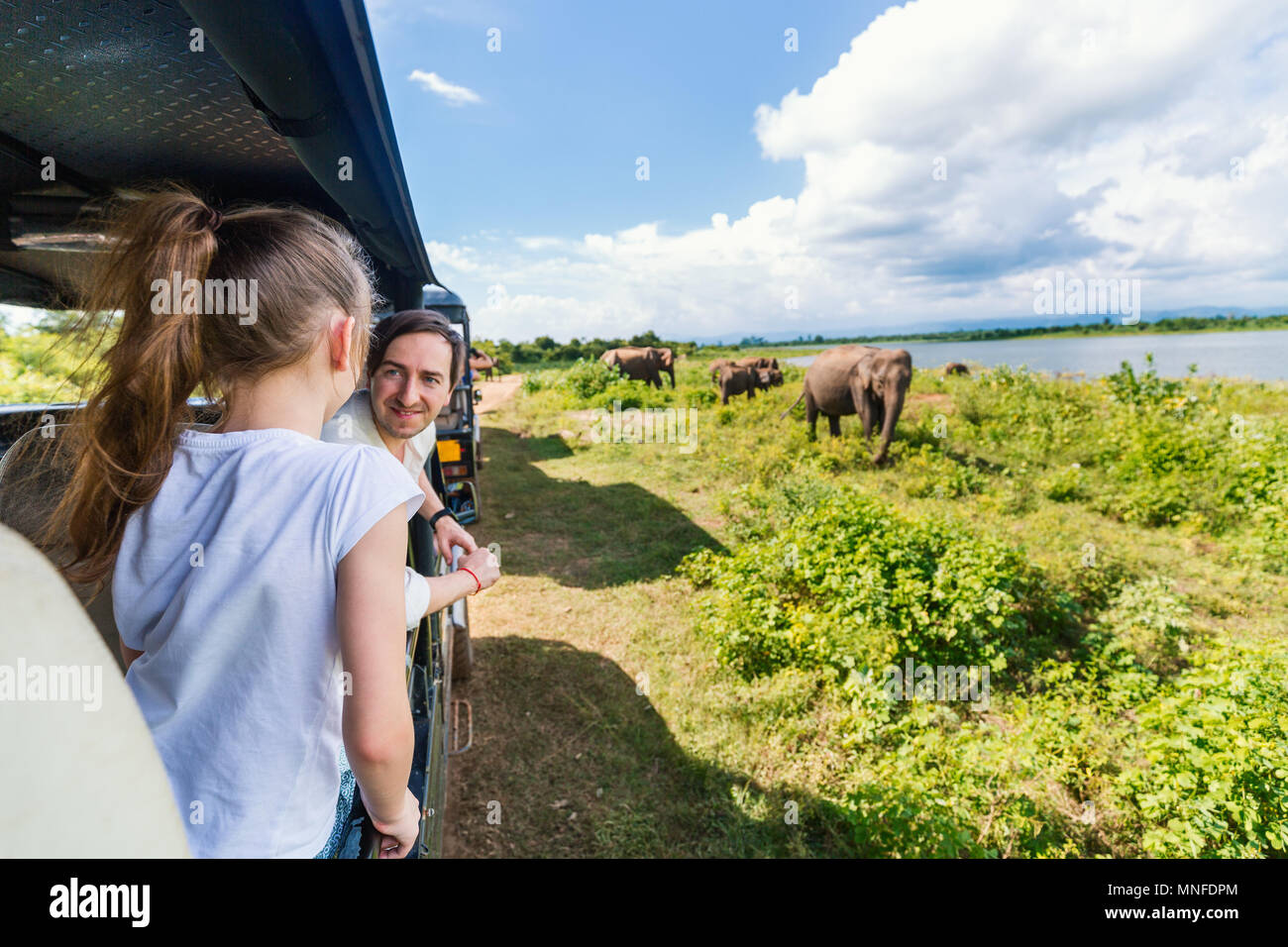 La famiglia del padre e figlia che guarda gli elefanti al Udawalawe parco nazionale in Sri Lanka Foto Stock
