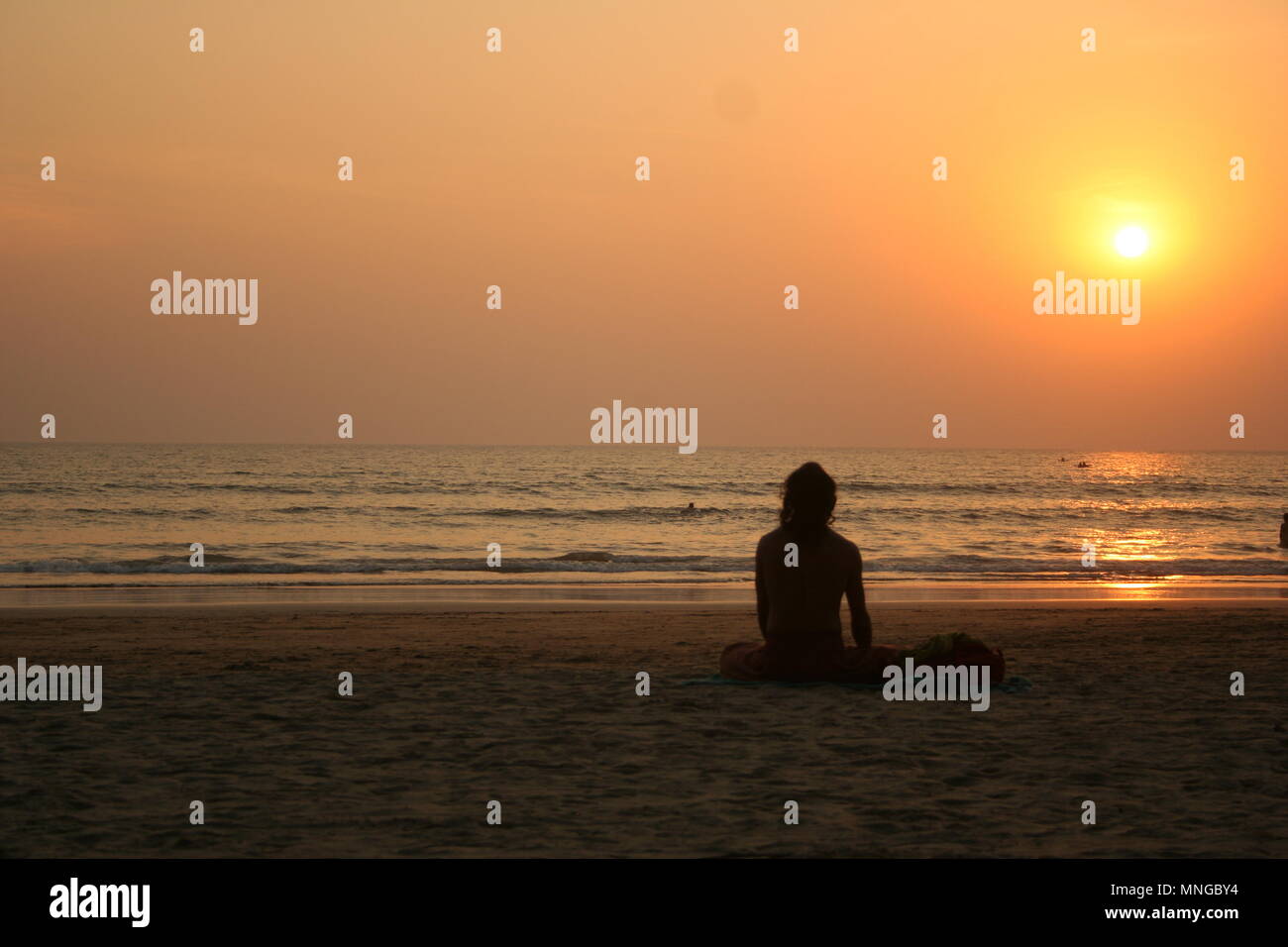 L'uomo a guardare il tramonto sulla spiaggia di Palolem, Goa Foto Stock