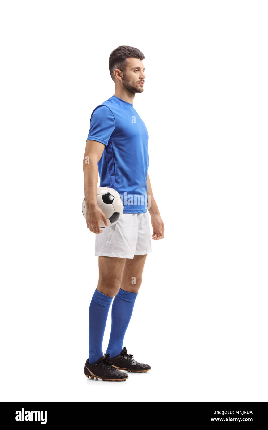 Lunghezza piena ripresa di profilo di un giocatore di calcio in attesa in linea isolati su sfondo bianco Foto Stock