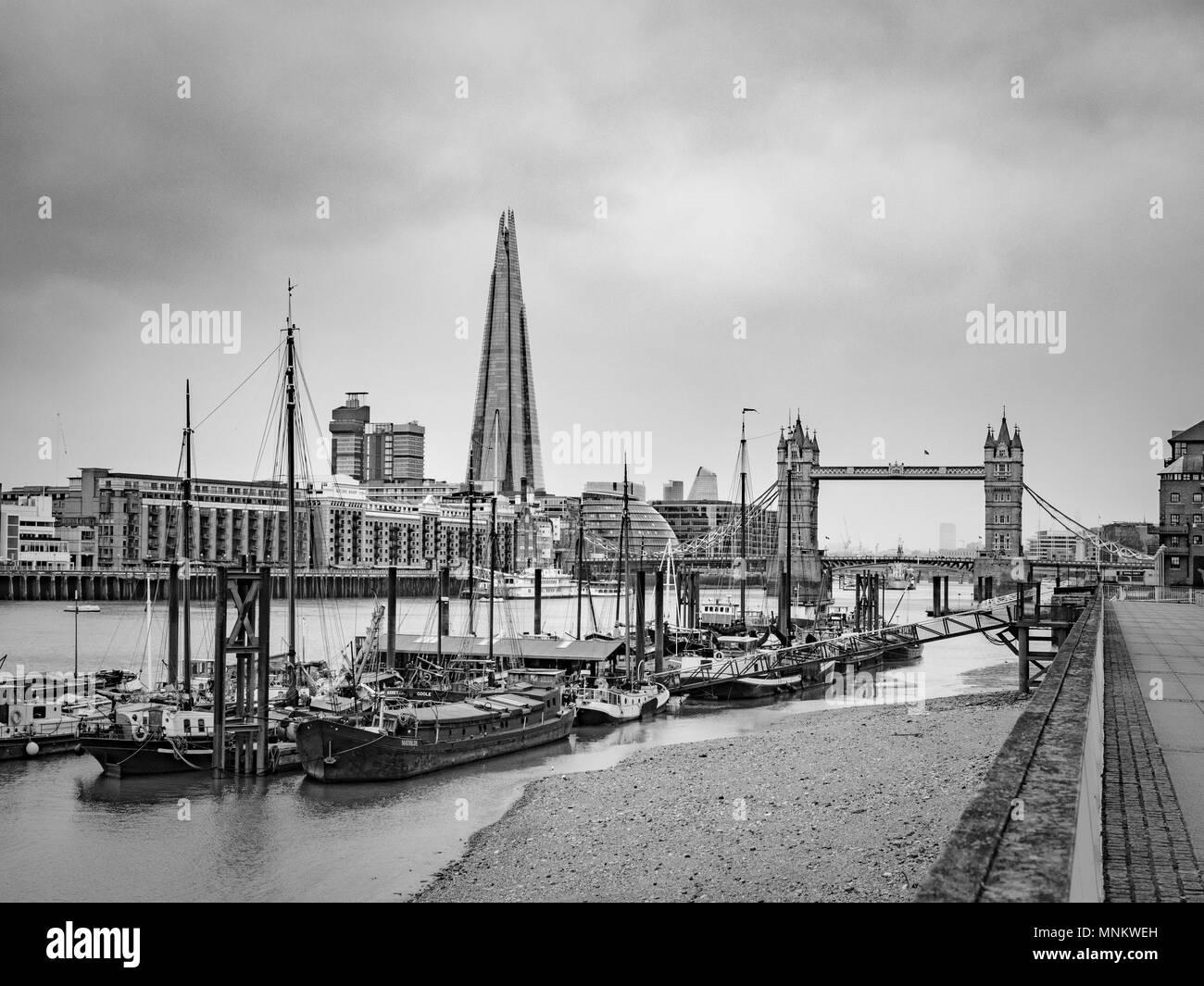 Il fiume Tamigi, barche, Tower Bridge e il Coccio dalla sponda nord del fiume, Londra, Regno Unito. Foto Stock