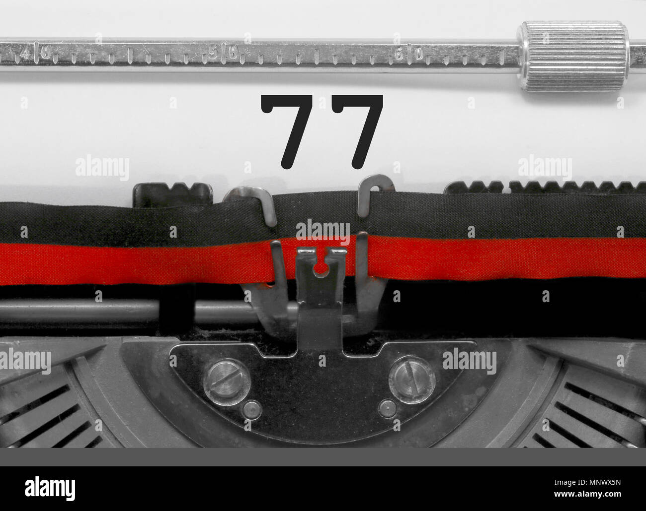 77 Numero testo scritto da una vecchia macchina da scrivere sul foglio bianco Foto Stock