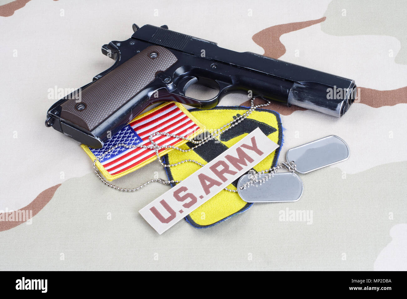 KIEV, UCRAINA - 18 maggio 2015. US Army 1a divisione di cavalleria patch con dog tag, governo colt M1911 su deserto uniforme Foto Stock