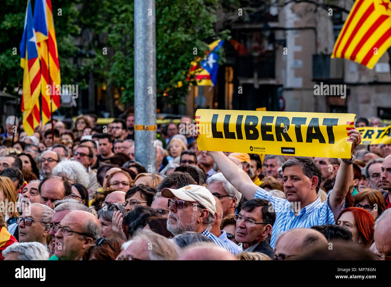 Un dimostrante è visto che mostra un poster per la libertà dei prigionieri politici in mezzo alla folla di contestatori. Centinaia di persone hanno concentrato la protesta della manutenzione dell'articolo 155 che impedisce il normale funzionamento del governo catalano e istituzioni dopo la nomina del presidente Quim Torra. Foto Stock