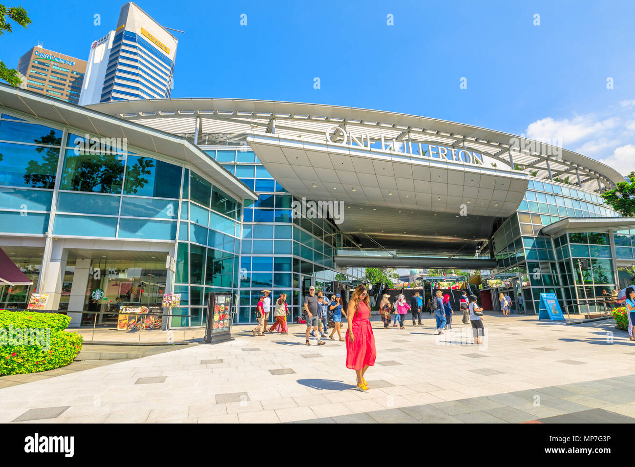 Singapore - Aprile 28, 2018: i turisti a piedi lungo la baia di Marina lungomare e a quella Fullerton centro commerciale adiacente al Parco Merlion e casa di una striscia di ristoranti e caffetterie. Foto Stock