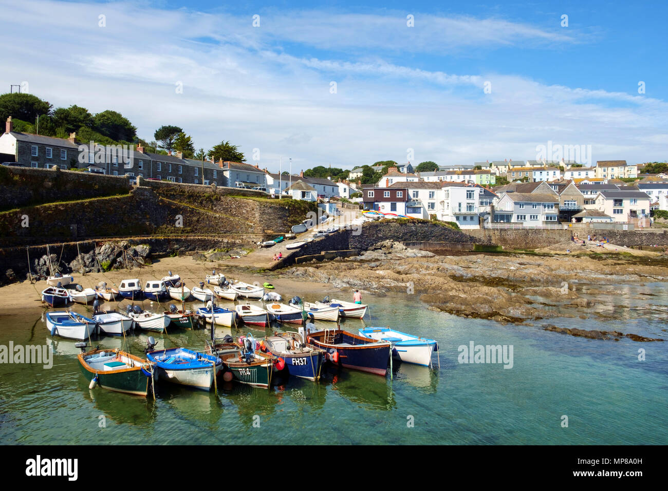Vacanzieri godere la calma le acque del porto e la fascia costiera a Portscatho, Cornwall, Regno Unito su una bella mattina d'estate. Portscatho è una famiglia di famose località meta di vacanza. Foto Stock