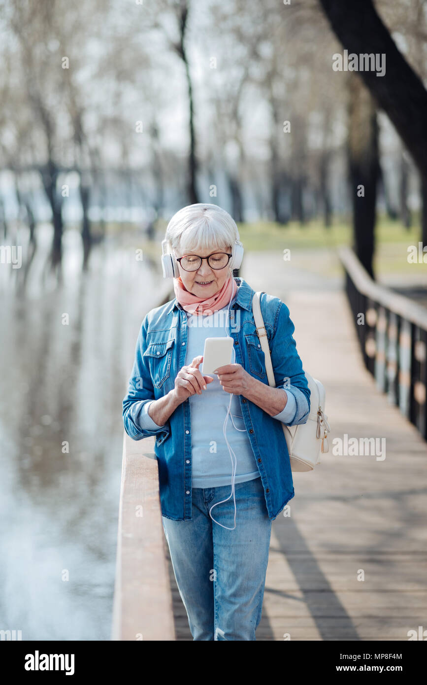 Alert donna matura l'ascolto di musica Foto Stock