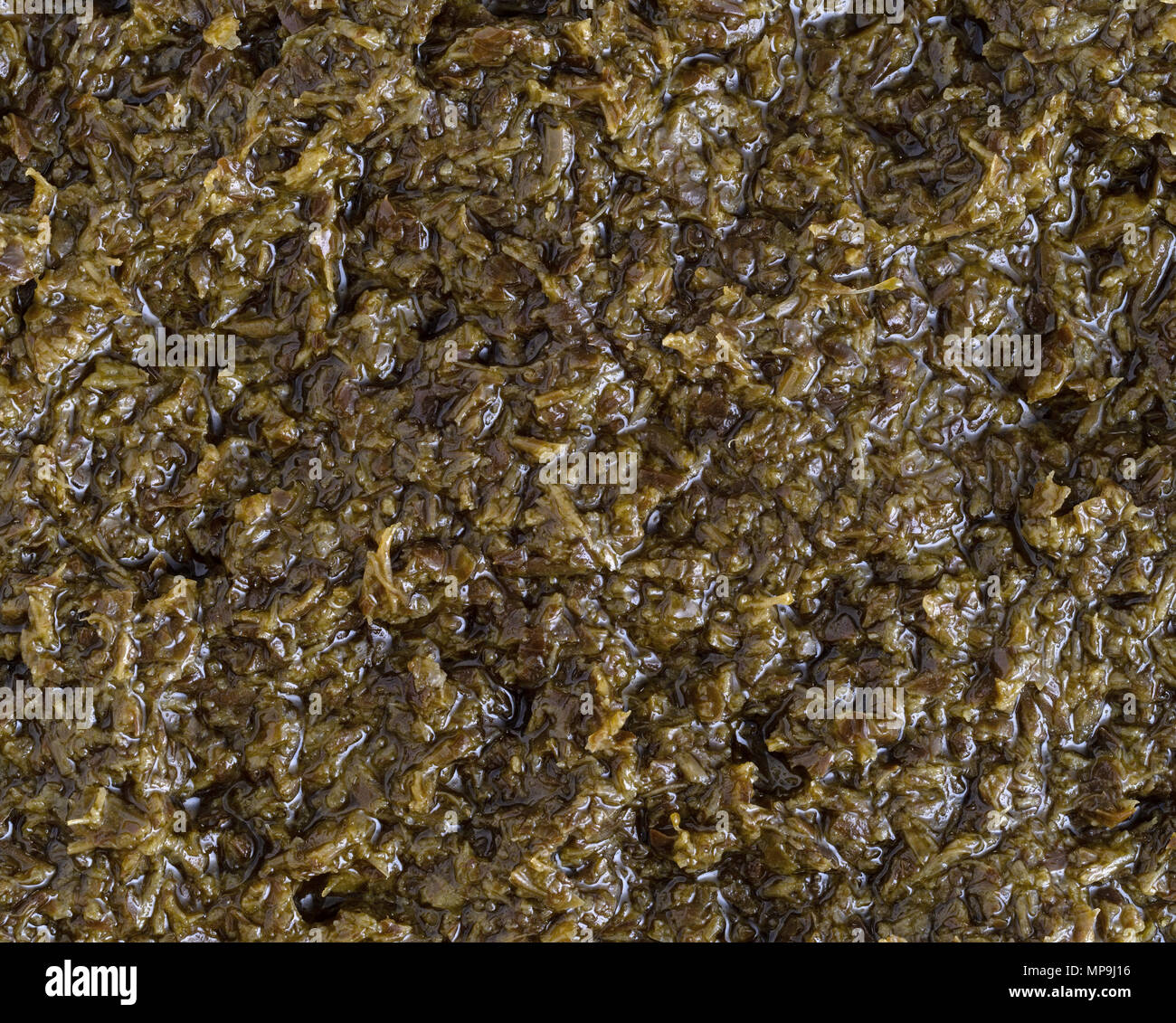 Top vista ravvicinata di prezzemolo tritato in olio di canola. Foto Stock Top vista ravvicinata di prezzemolo tritato in olio di canola. Foto Stock