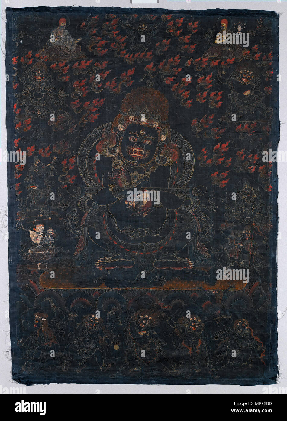 . Inglese: Mahakala, protettore della tenda, il Tibet. Il cimurro e oro su seta blu, Immagine: 29 x 20 1/2 in. (73,7 x 52,1 cm) complessivo: 30 1/4 x 21 3/4 in. (76,8 x 55,2 cm). Questo nero dipinto di massa è una visualizzazione immagine di Mahakala come Panjarantha, gli illuminati protettore del buddhismo. Egli calpesta un cadavere maschile sotto i suoi piedi e visualizza un coltello scotennatrice (kartrika) nella mano destra e una coppa del cranio (kapala) nella sua sinistra, attrezzi per il taglio attraverso delusioni e ignoranza. Un rituale wand (gandi) è bilanciata in uncini delle sue braccia. Panjaranatha è inteso come la "originale" Mahakala Foto Stock