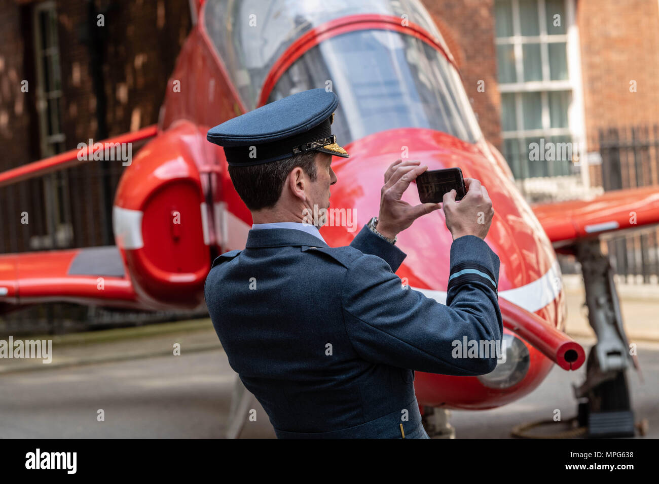 Londra, Regno Unito. 23 Maggio, 2018. Un senior ufficiale della RAF prende un selfie accanto a un Hawker Siddeley Hawk - freccia rossa aeromobile a Downing Street per l anniversario della fondazione della RAF, Credito Ian Davidson/Alamy Live News Foto Stock