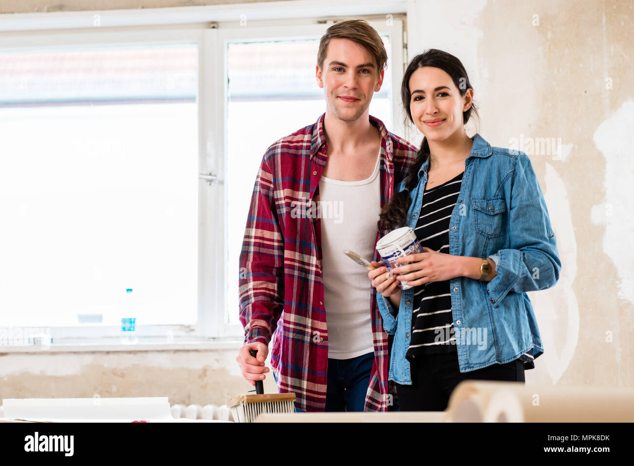 Ritratto di una felice coppia giovane azienda gli strumenti per il rimodellamento di casa Foto Stock
