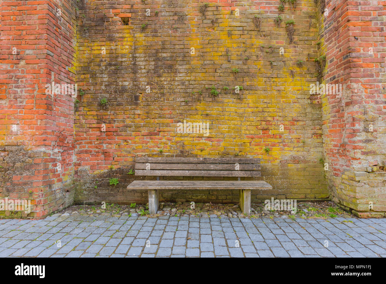 In Germania, in Baviera, Memmingen, panca in legno e la parete della città Foto Stock