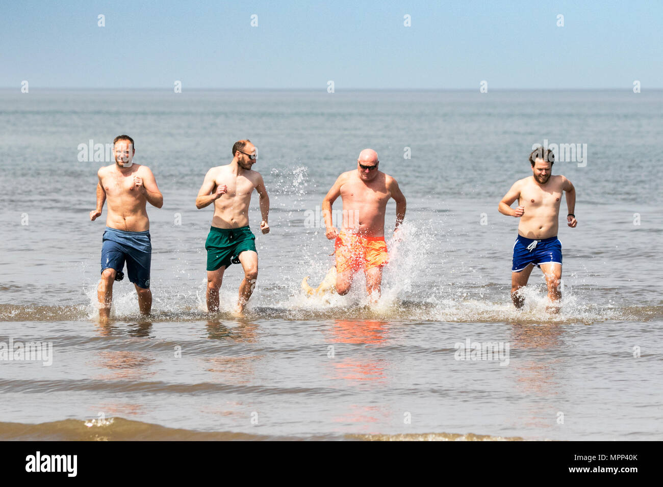 Southport, Merseyside. Regno Unito Meteo. Un padre e i suoi tre figli godono di una buona qualità del tempo in famiglia giù al mare in Southport godendo una giornata di belle il sole caldo e il cielo limpido su di una splendida primavera pomeriggio. Credito: Cernan Elias/Alamy Live News Foto Stock