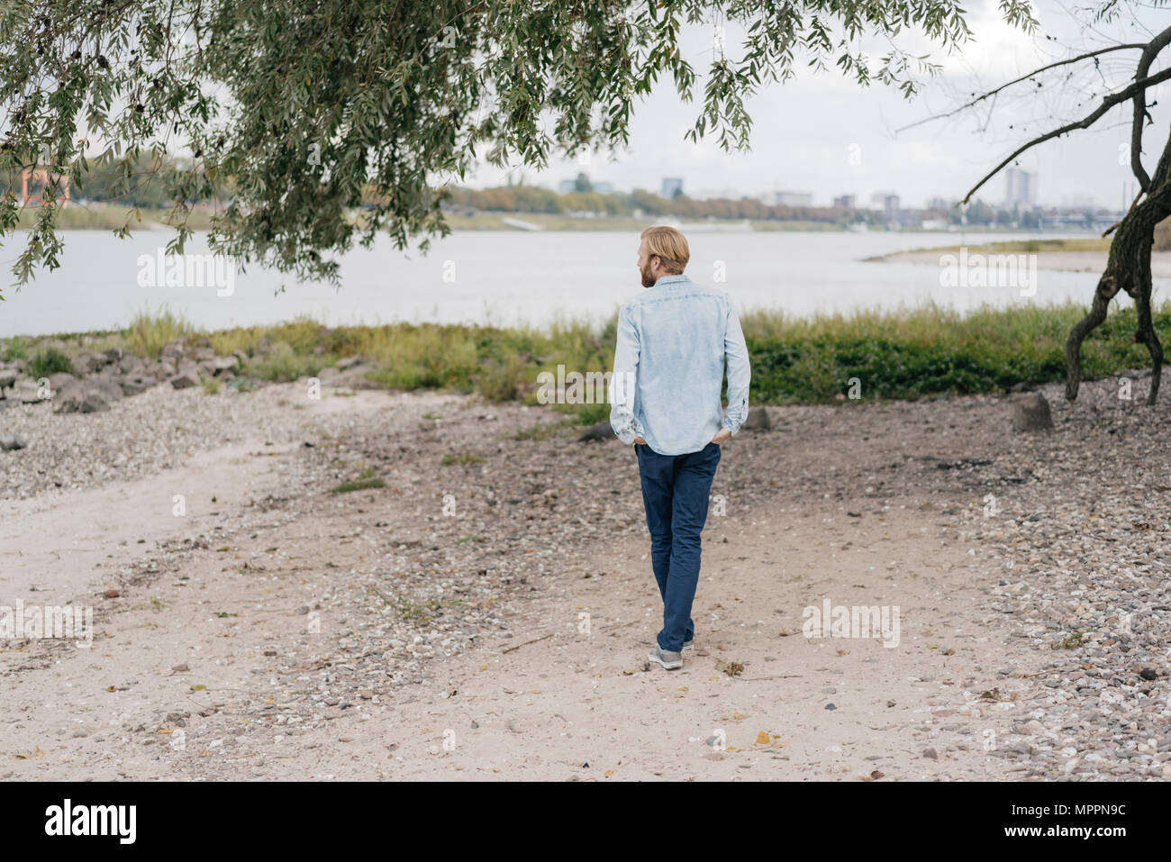 Germania, Duesseldorf, vista posteriore dell uomo in piedi sulla spiaggia Foto Stock