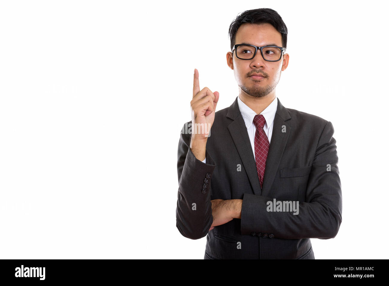 Studio shot del giovane imprenditore asiatico puntare il dito mentre Foto Stock