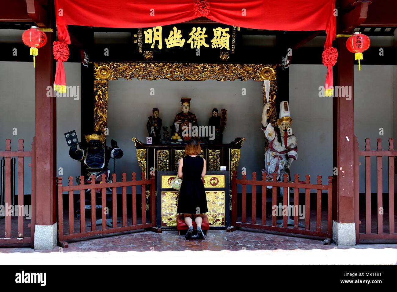 Singapore - 15 Maggio 2018: donna cinese pregando in un buddista taoista di edicola decorata per giorno Vesak in onore di Buddha in Telok Ayer, Singapore Foto Stock