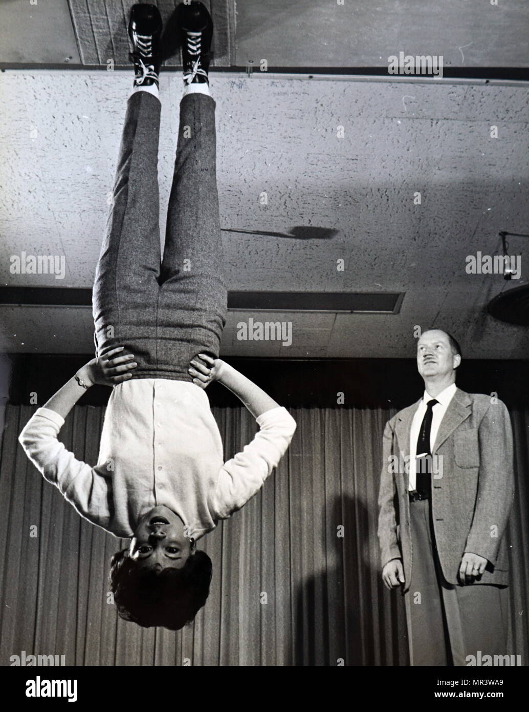 Fotografia che ritrae Nancy Wendler dimostrando a gravità zero scarpe per  loro developer, John F. sentito. Le suole delle scarpe sono coperti con  minuto ganci di nylon che si impegnano con una