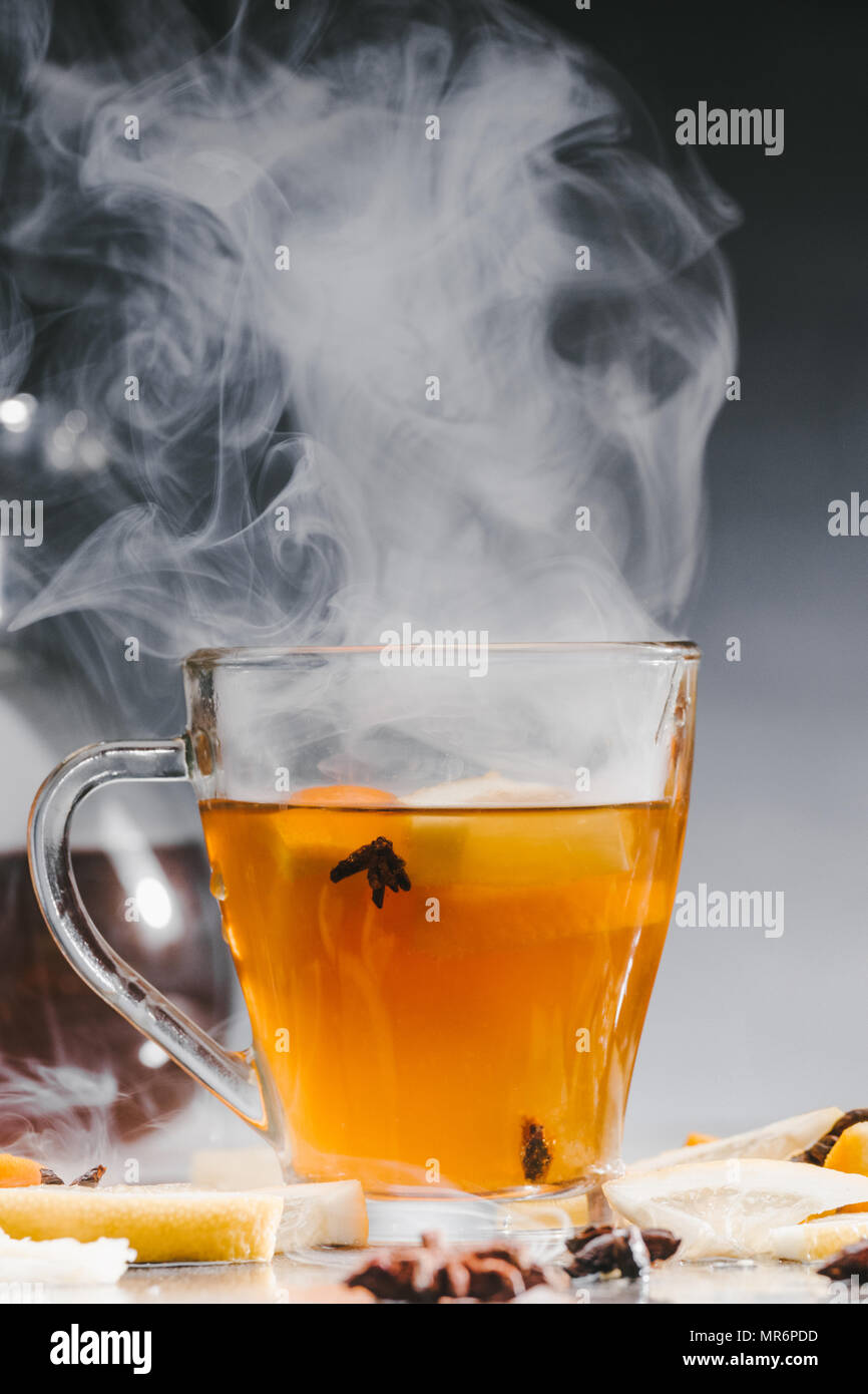 Bicchiere di vetro di caldo tè fumante Foto Stock