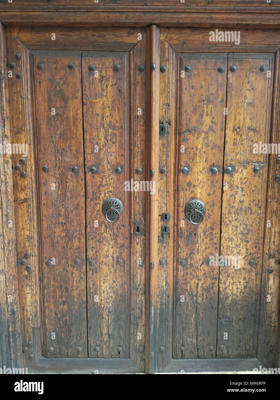 Porta di legno e arrugginita vecchia maniglia della porta Foto Stock