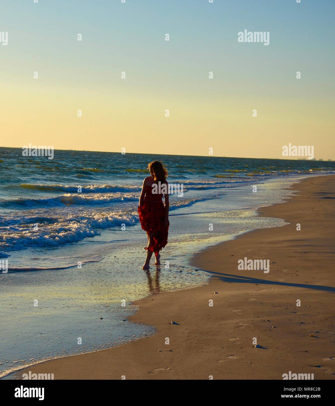 Camminare sulla spiaggia al tramonto. Foto Stock