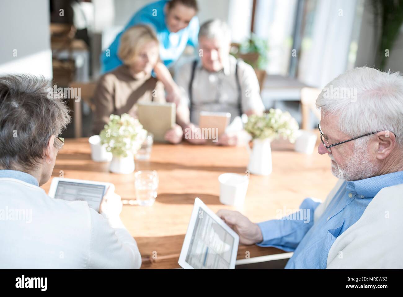 Senior adulti utilizzando le compresse di digitale in casa di cura. Foto Stock