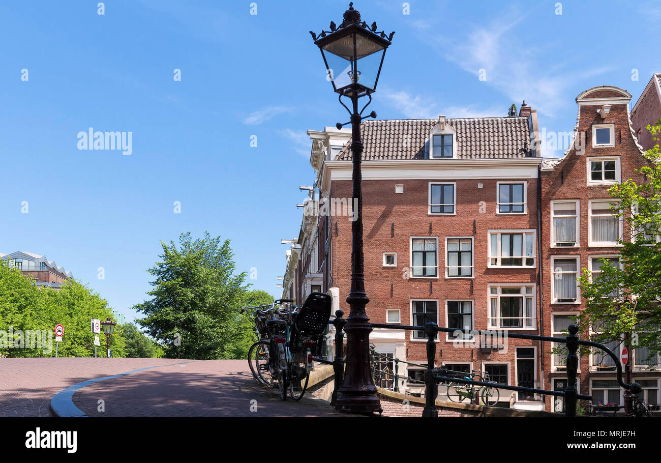 Tipiche vecchie case di Amsterdam sotto il cielo blu. Foto Stock