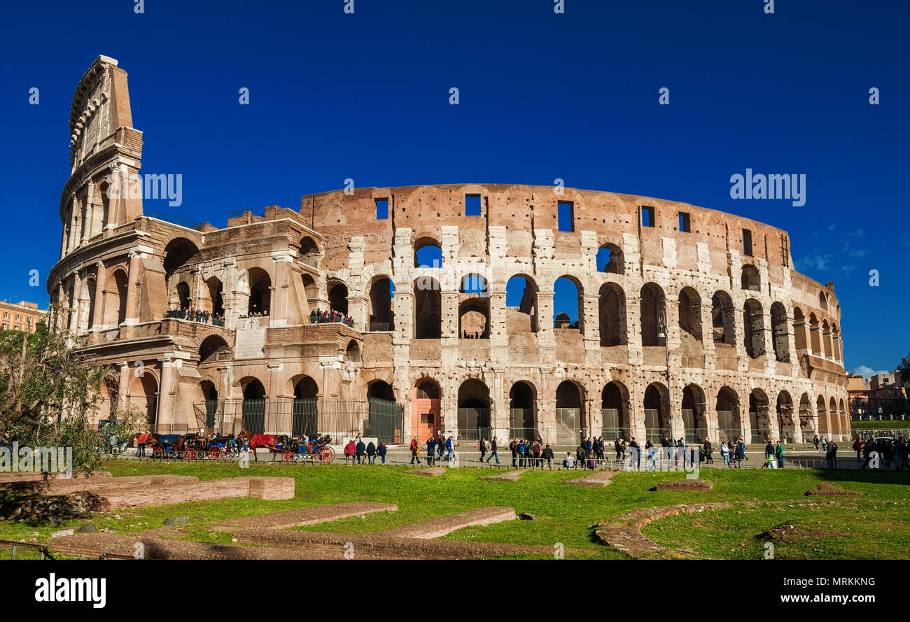 Colosseo con escursionisti e 'botticelle', la caratteristica romana carretti a cavallo Foto Stock