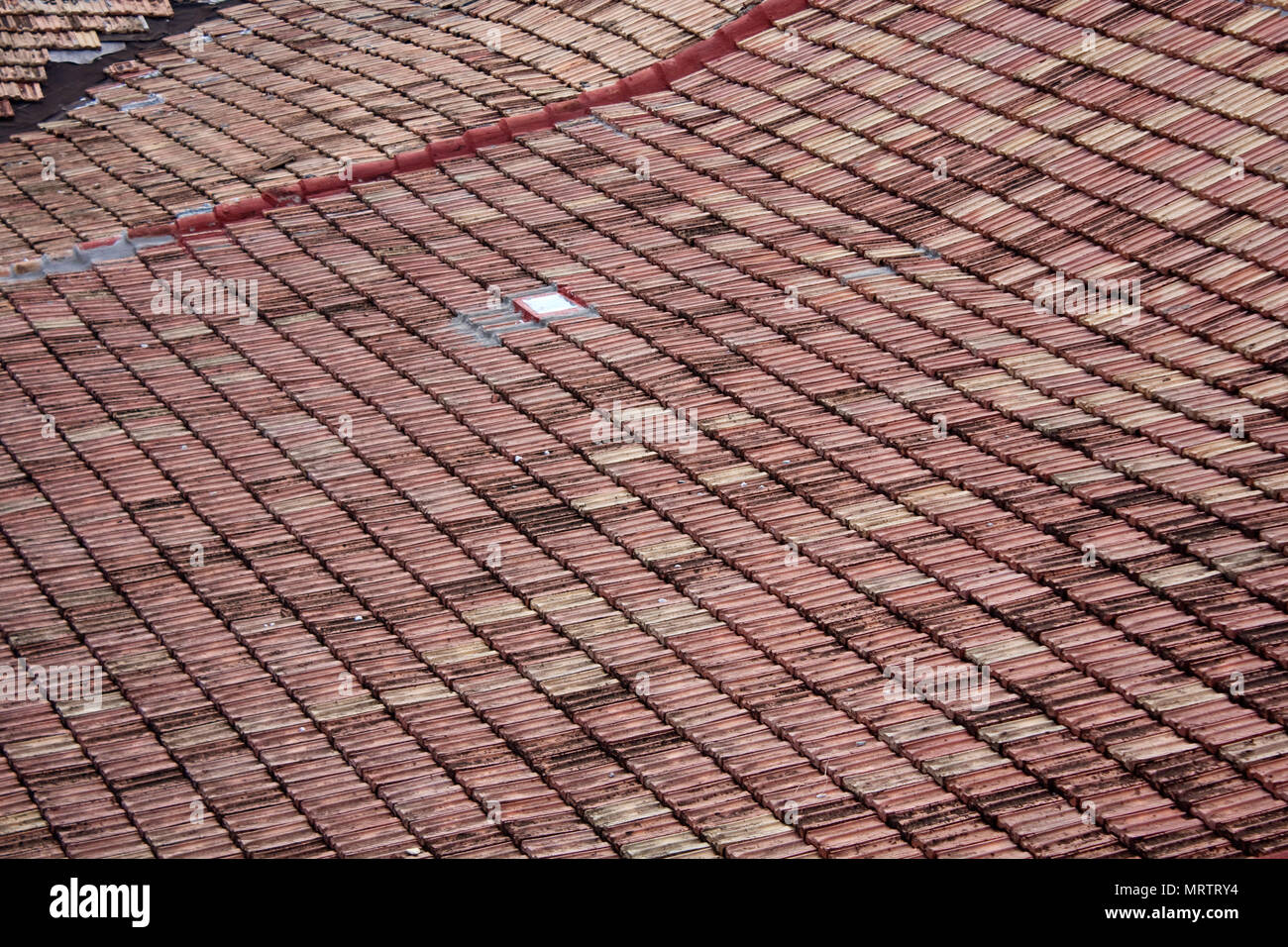 Finestra di piccole dimensioni situato su weathered tetto di tegole di casa in Trinidad, Cuba. Foto Stock