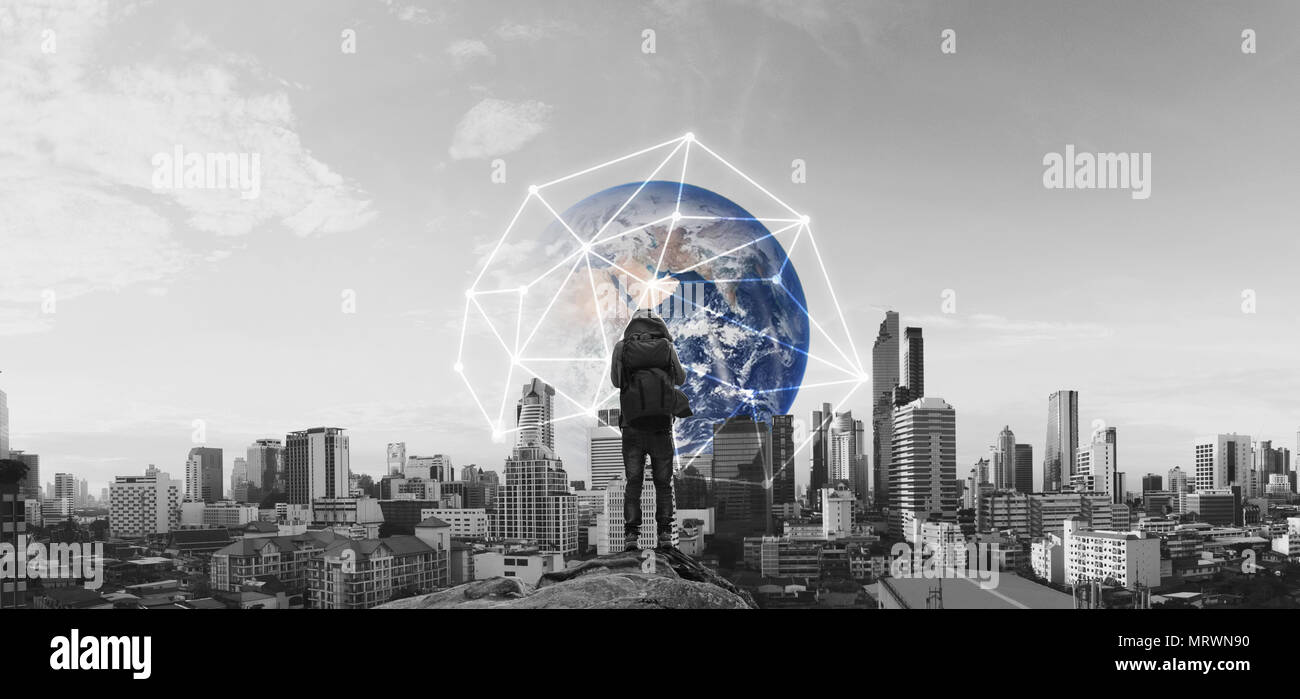 Un uomo con zaino in piedi sulla roccia, e vista sulla città con la rete globale di connessione. Elemento di questa immagine sono arredate dalla NASA Foto Stock