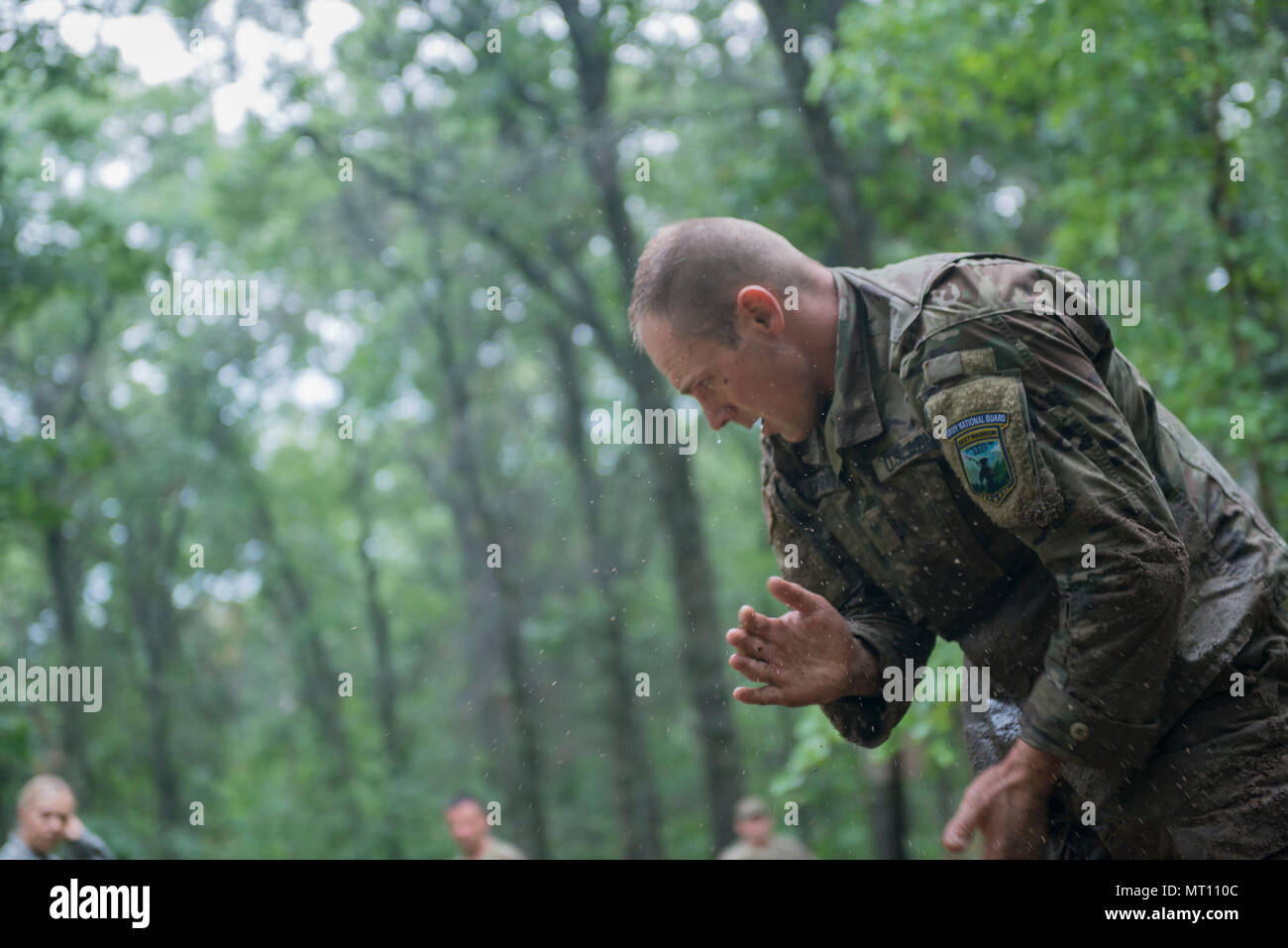 Spc. Robert Kniprath, una scout di cavalleria con C truppa, 1° Stormo, 105Cavalleria, XXXII IBCT, Wisconsin Guardia nazionale, spazzole fuori le mani dopo aver completato la high-crawl ostacolo sulla fiducia corso durante il 2017 esercito nazionale Guard guerriero migliore concorrenza sulla luglio 18, 2017, a Camp Ripley, Minn. Questo è stato il quinto appuntamento della giornata i concorrenti completato il secondo giorno della concorrenza. (Minnesota Guardia Nazionale foto di Sgt. Sebastian Nemec) Foto Stock