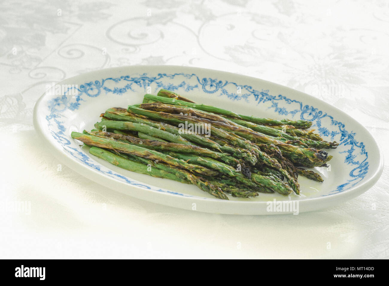 Asparagi arrostito su un vintage piatto di portata Foto Stock